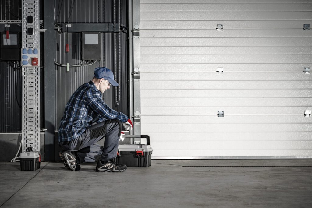 Caucasian,Technician,In,His,40s,Servicing,Commercial,Dock,Garage,Gate.