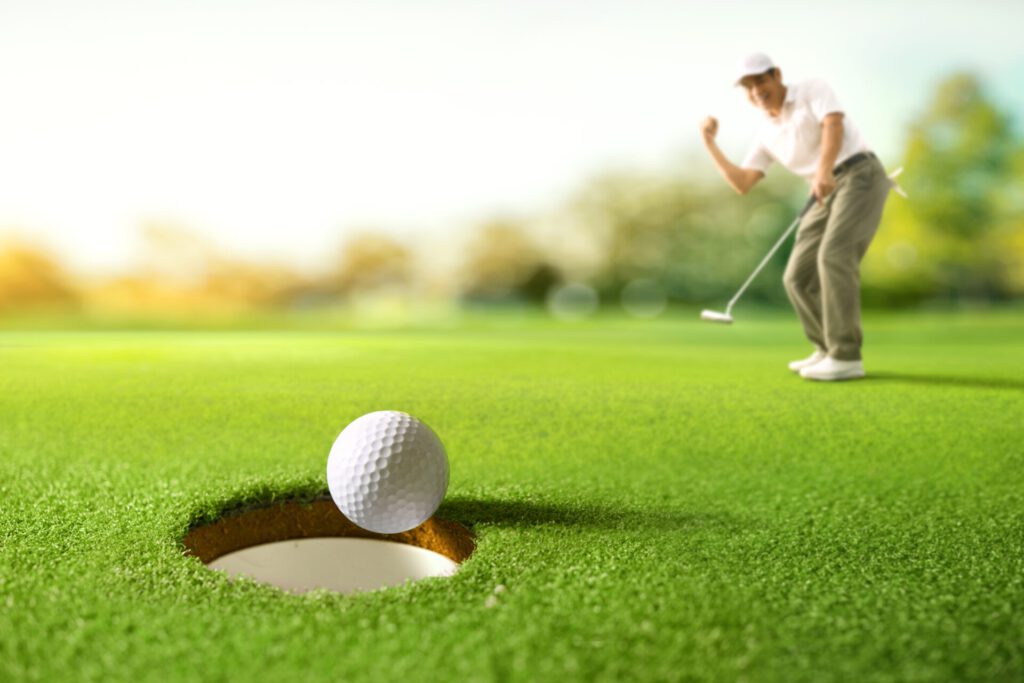 Golf,Ball,Drop,Into,The,Hole,After,Golfer,Putting.