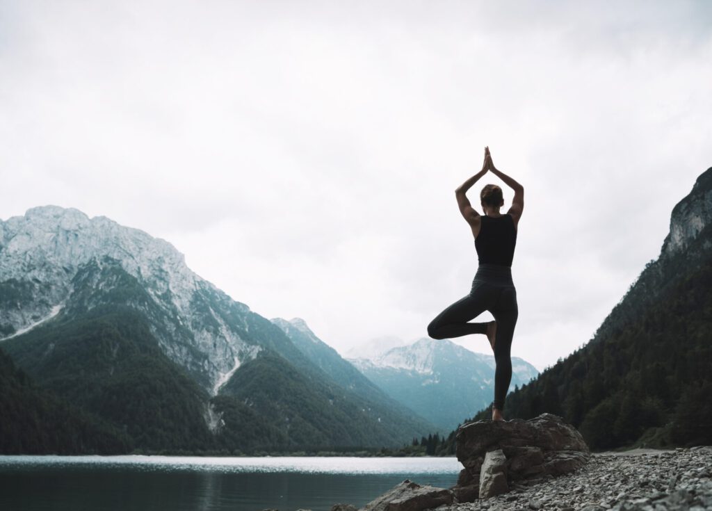 Young,Woman,Is,Practicing,Yoga,At,Mountain,Lake.,Girl,Doing