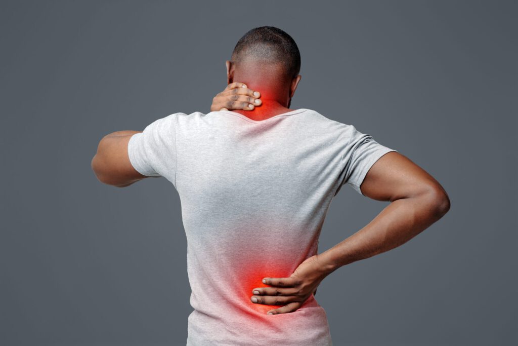African,Man,With,Neck,And,Back,Pain,,Rubbing,His,Painful